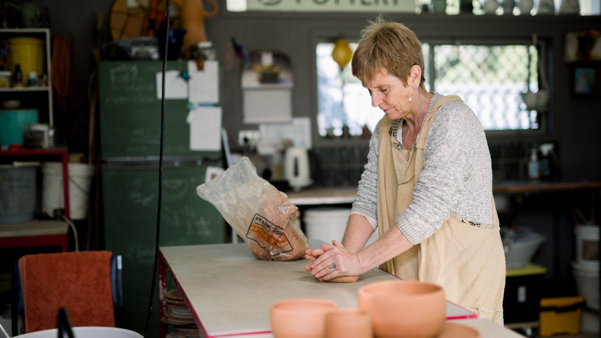 potter in studio making pots