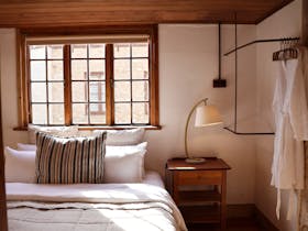 Bedroom with French doors opening to outdoor courtyard at 1856 Cottage in Robe South Australia