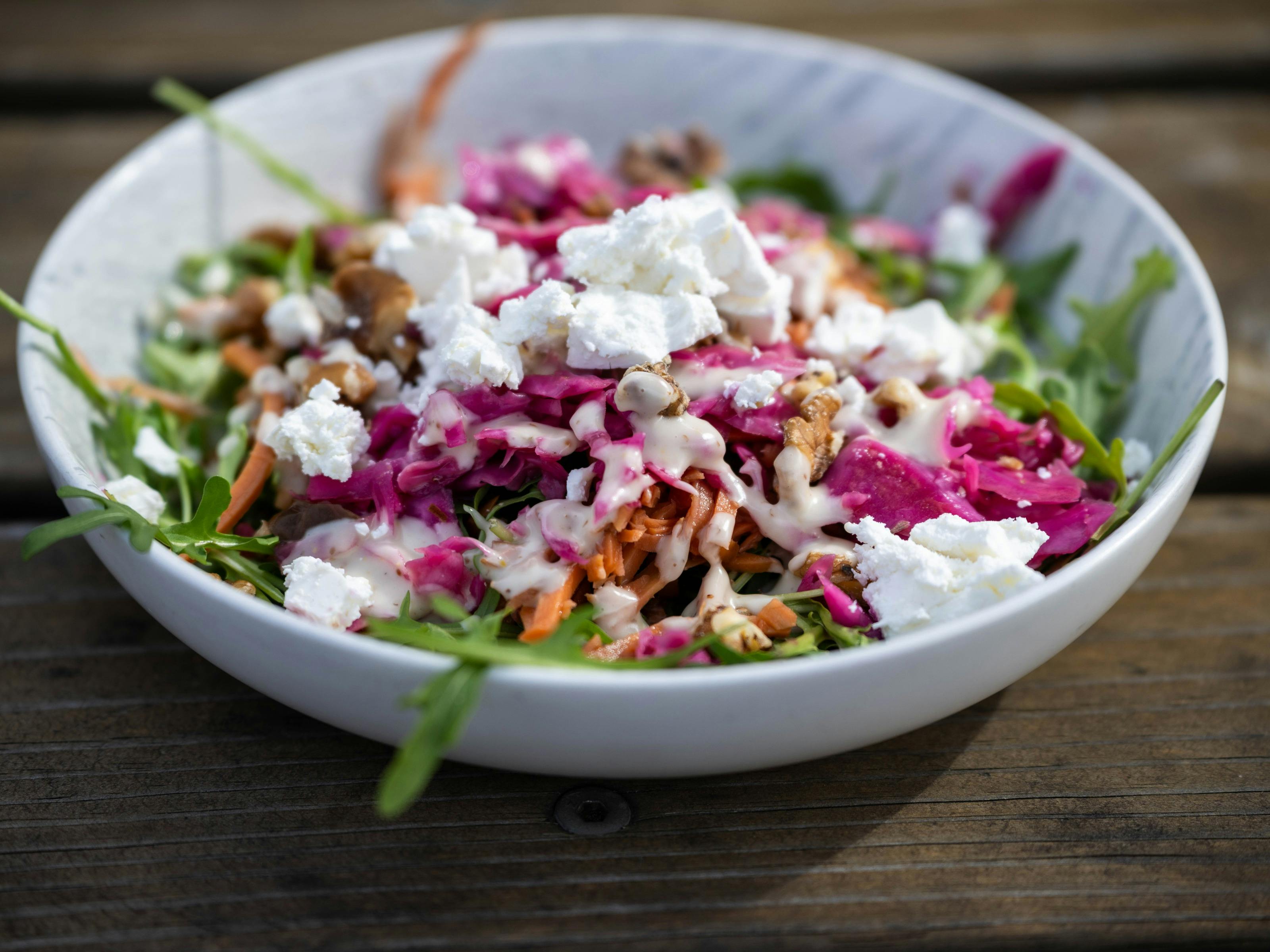 Fresh rocket salad with pickled vegetables, walnuts, feta and a light house dressing.