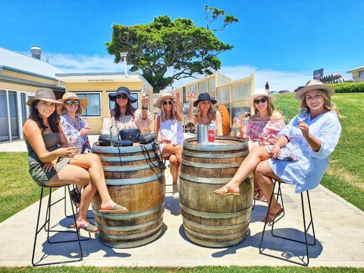 wine tastings outdoors group of girls barrels
