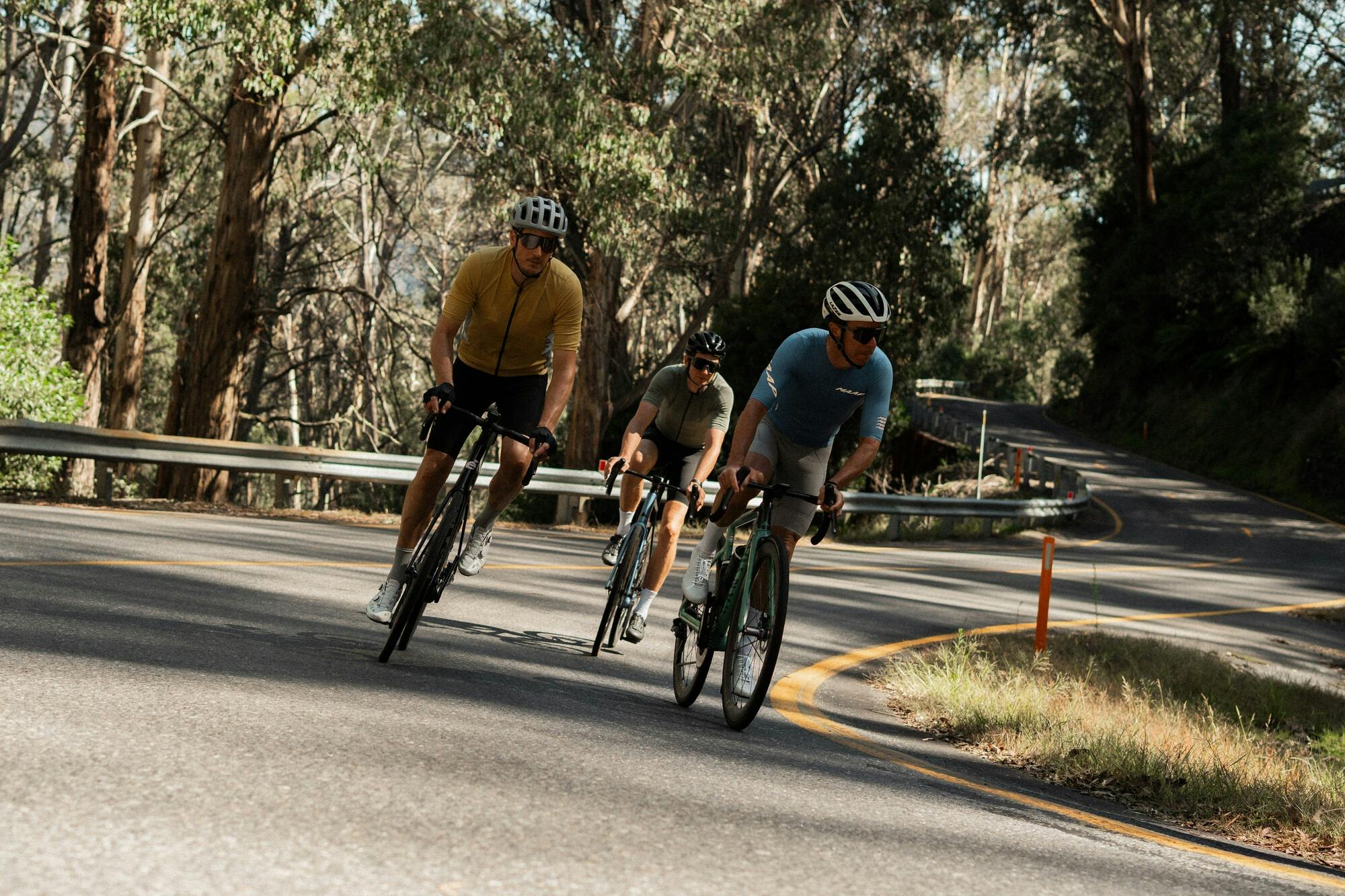 Three cyclists riding hard on the Falls Creek 7 Peaks Challenge route