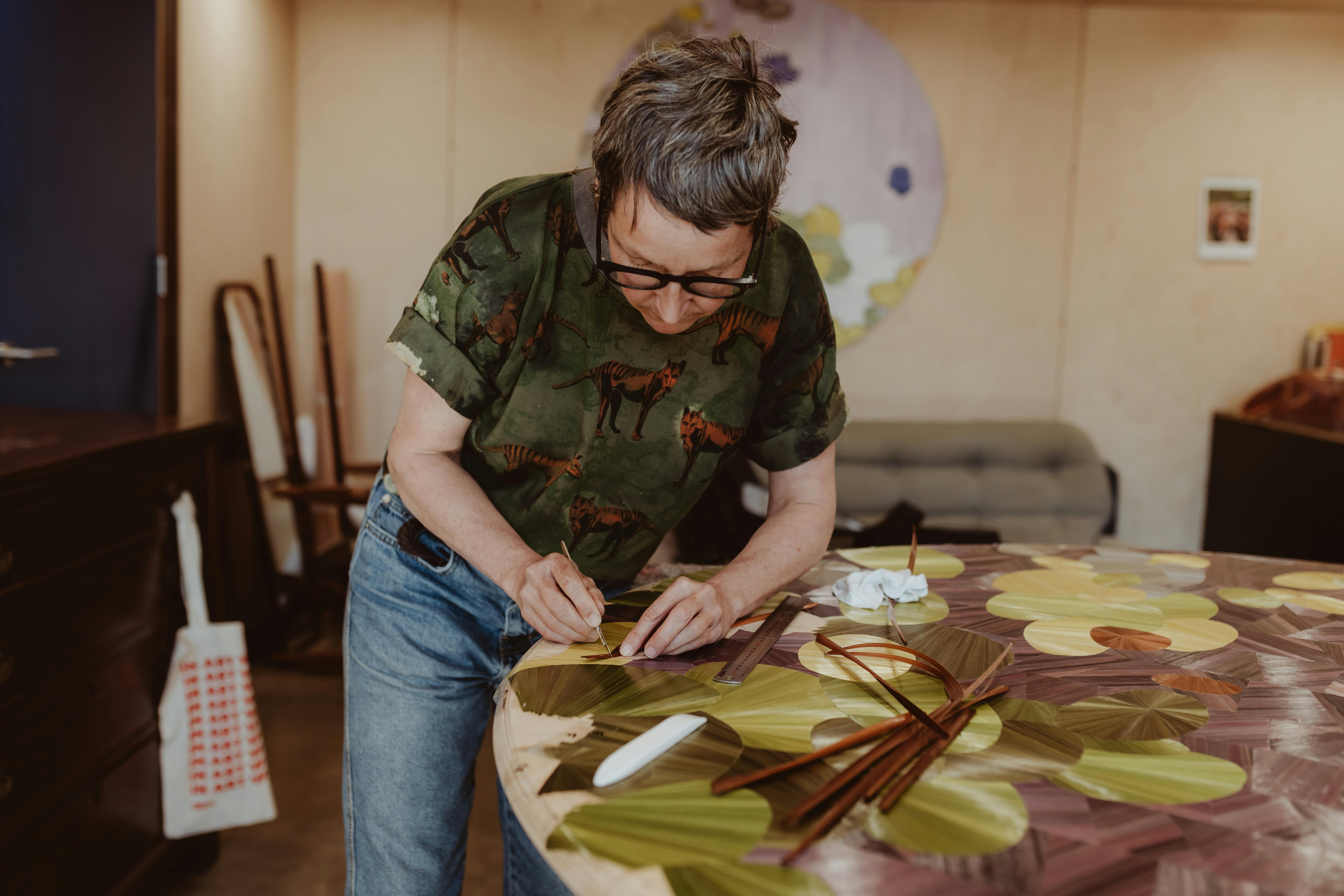 Inke Falkner using the technique of French straw marquetry on her artwork Round and Round