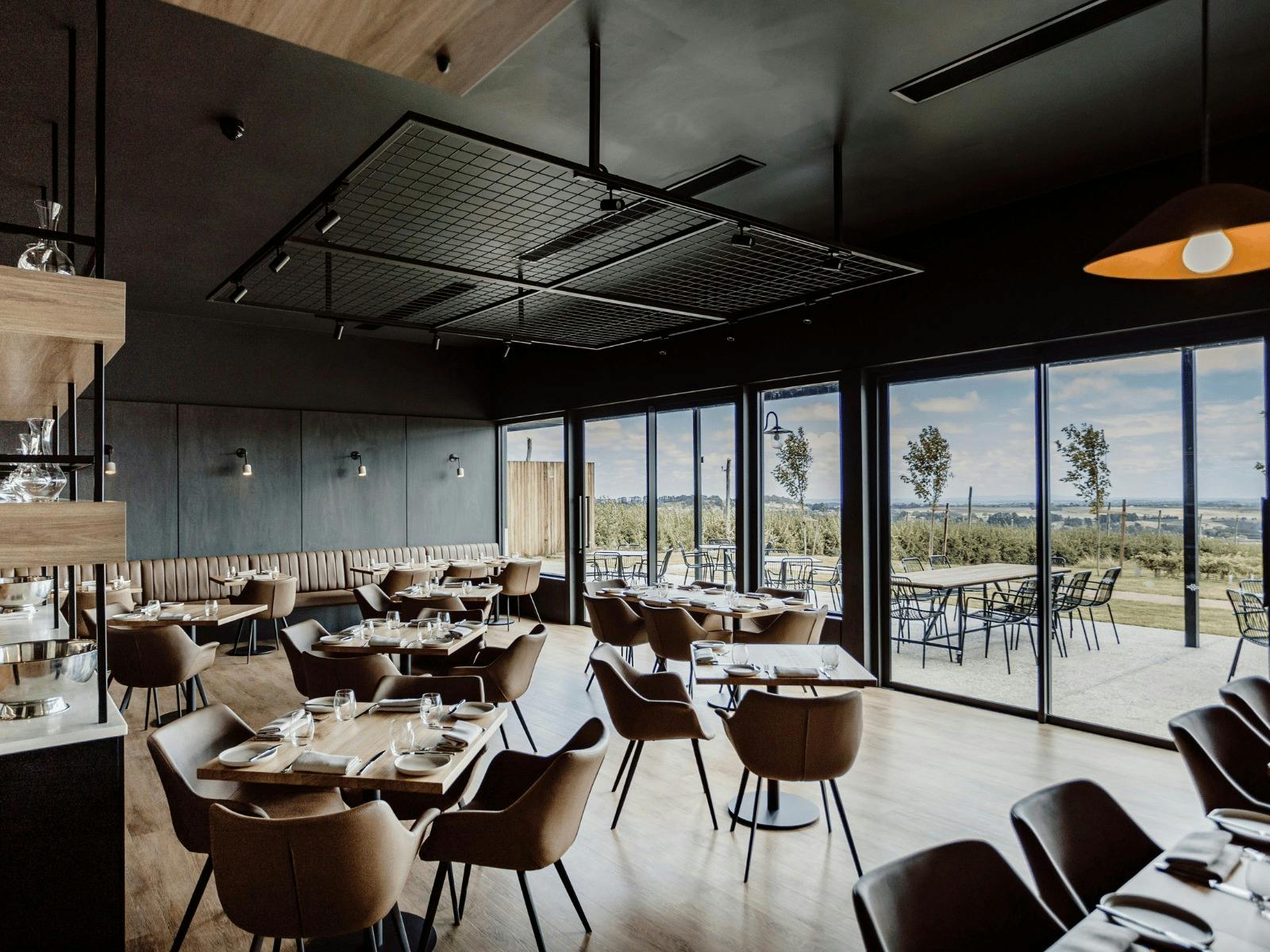 Printhie Dining room showing comfy leather tub chairs and views across the valley through the window