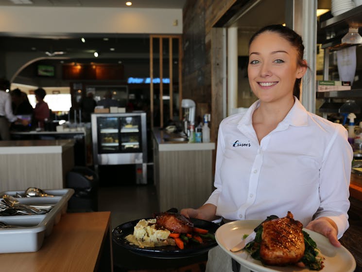 Waitress holding plates of food