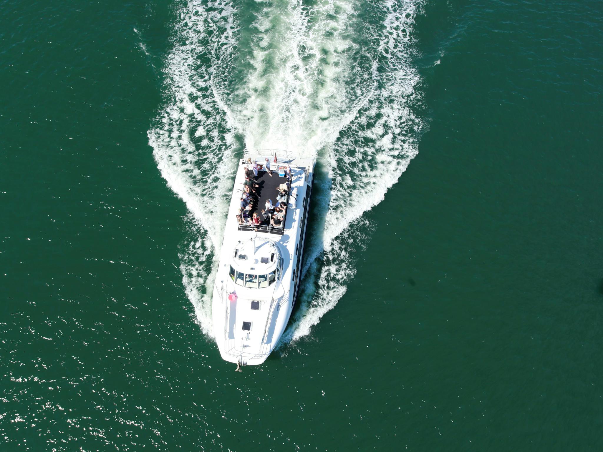 Picture looking down on vessel 'Bay Connections' cruising on the water in Newcastle Harbour