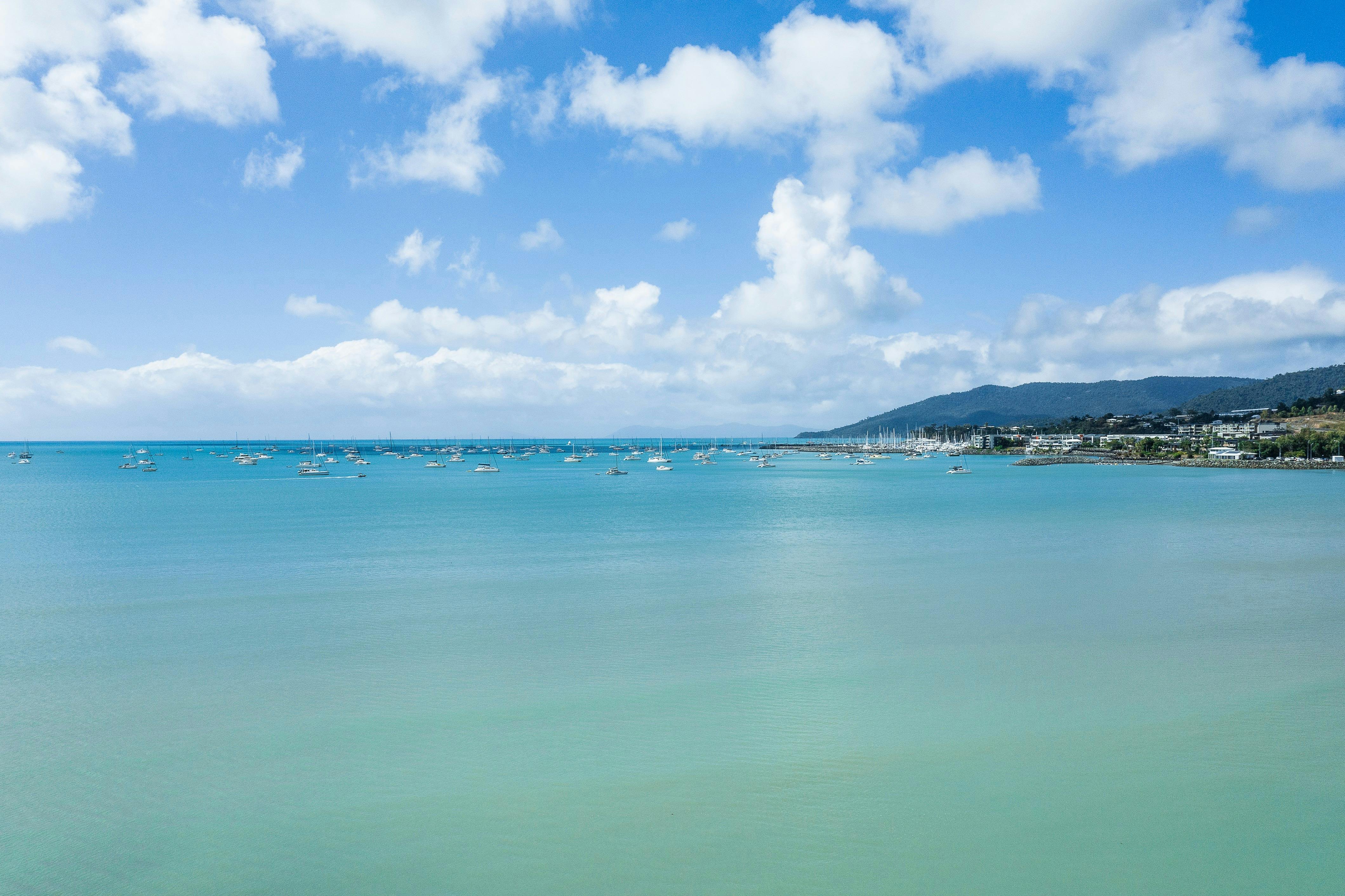 Ocean view from Cannonvale Beach overlooking sailing boats and Airlie Beach in the background