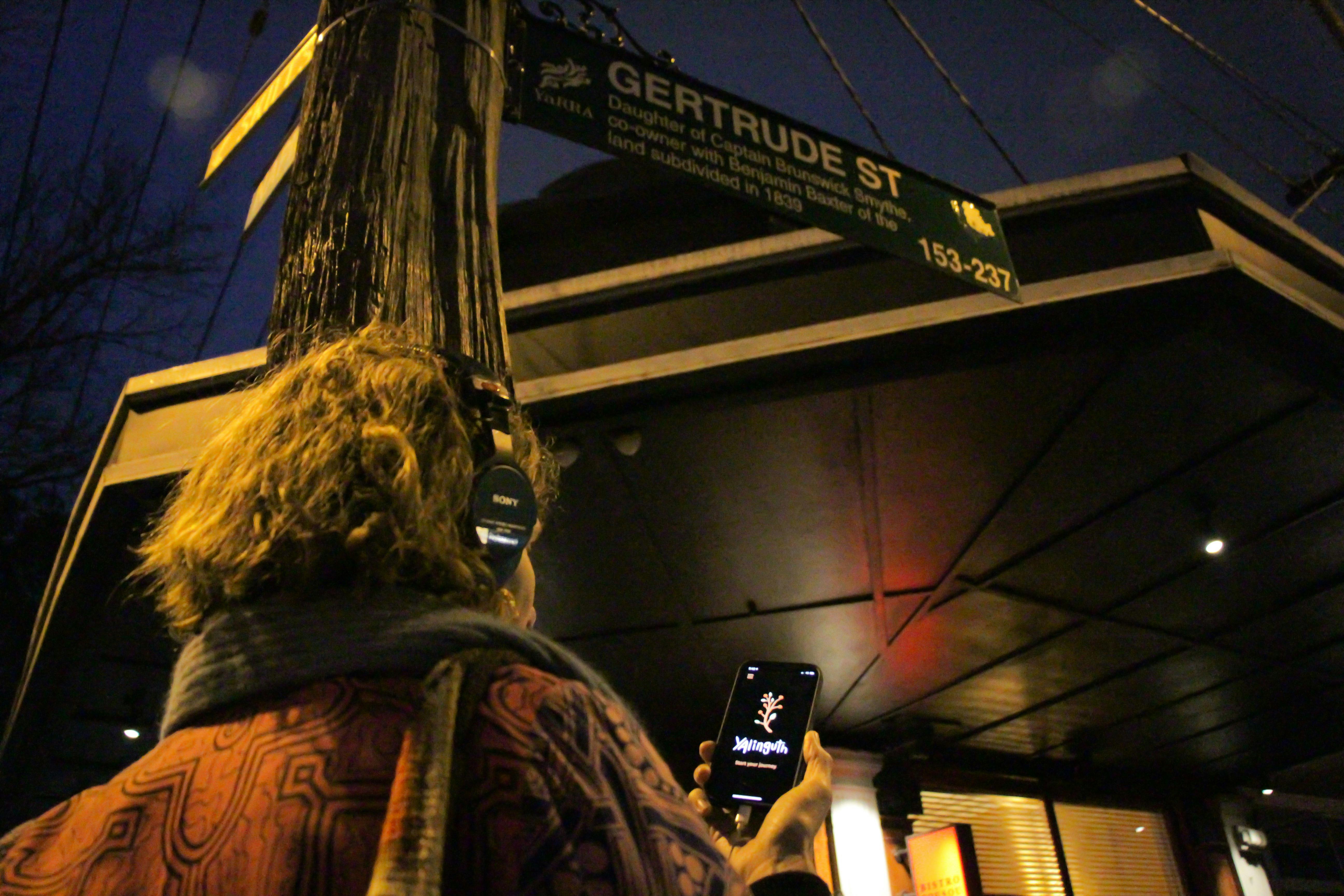 Listening to the Yalinguth app on Gertrude St, Fitzroy