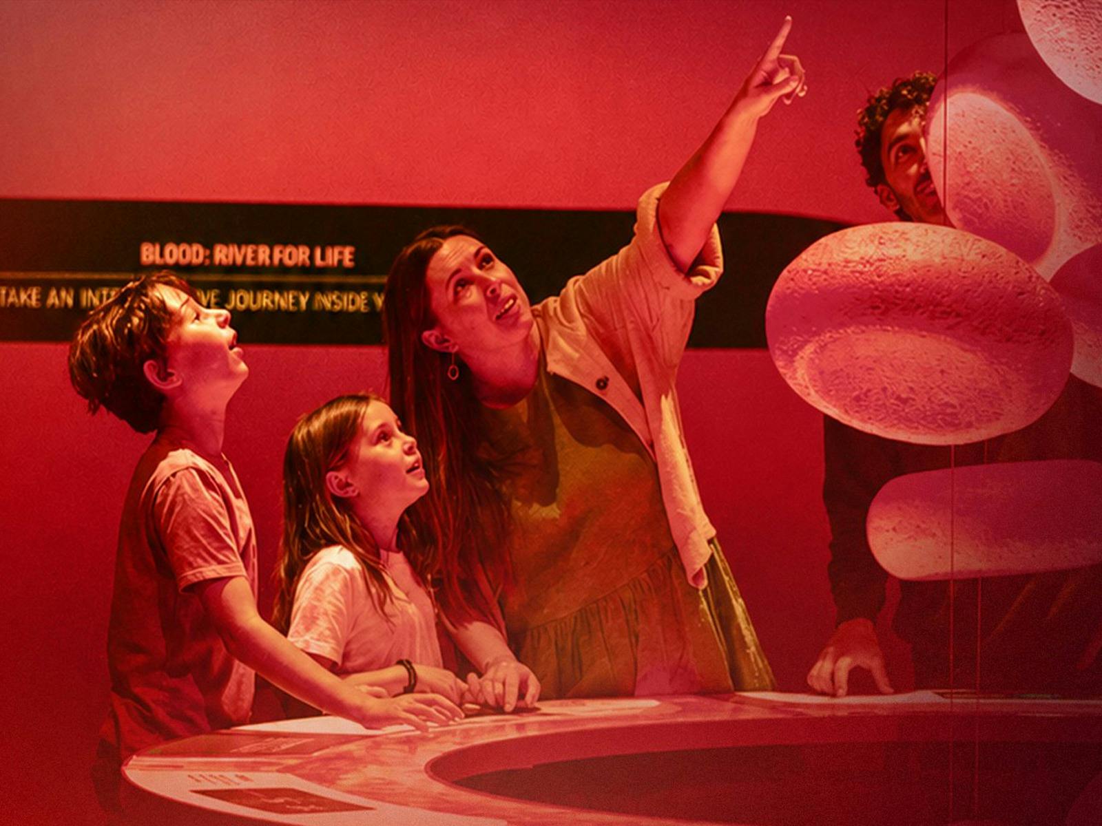 A family with two children exploring the Bloodsuckers exhibition