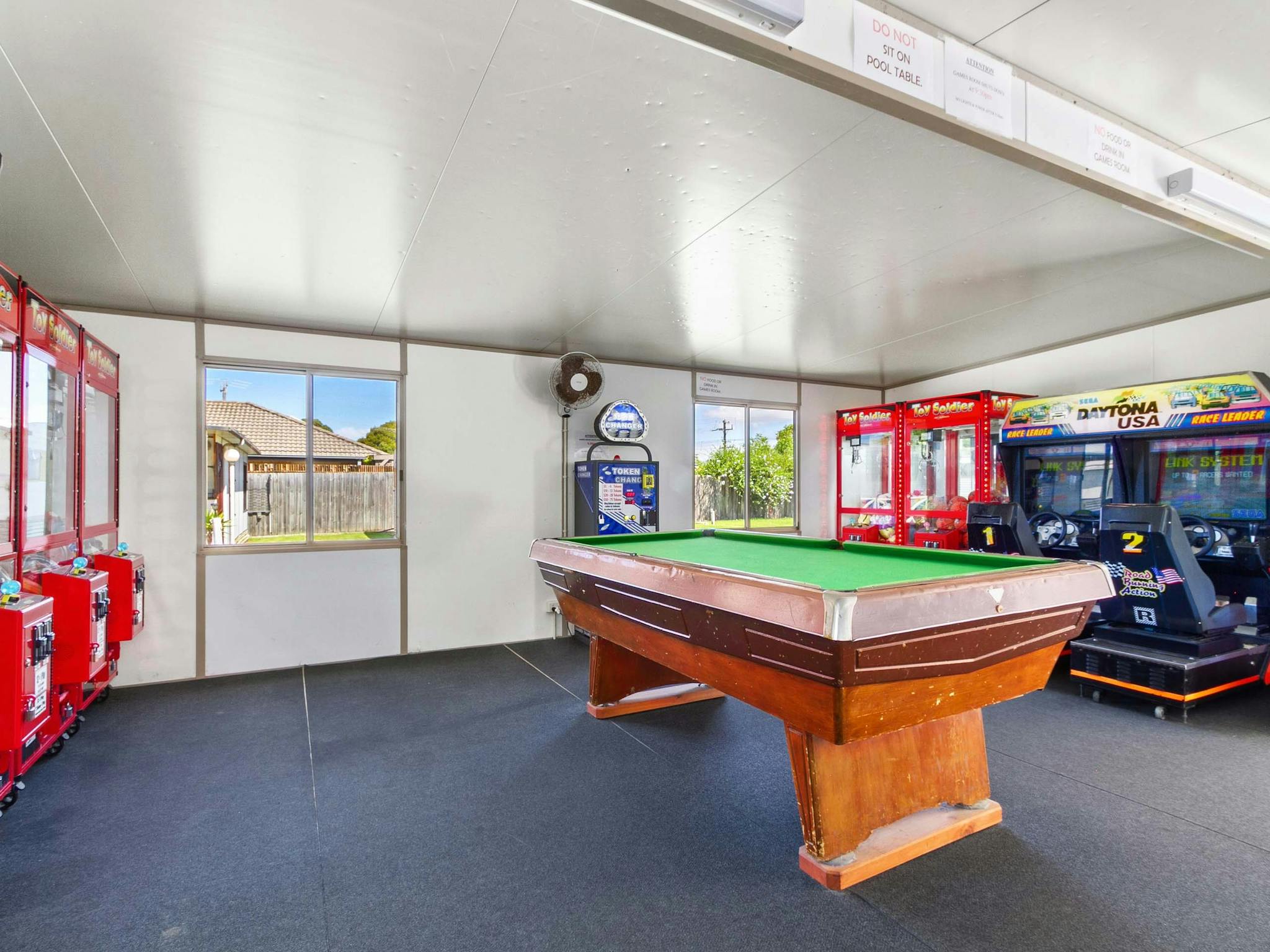 Games room, with pool table and arcade games in the background.