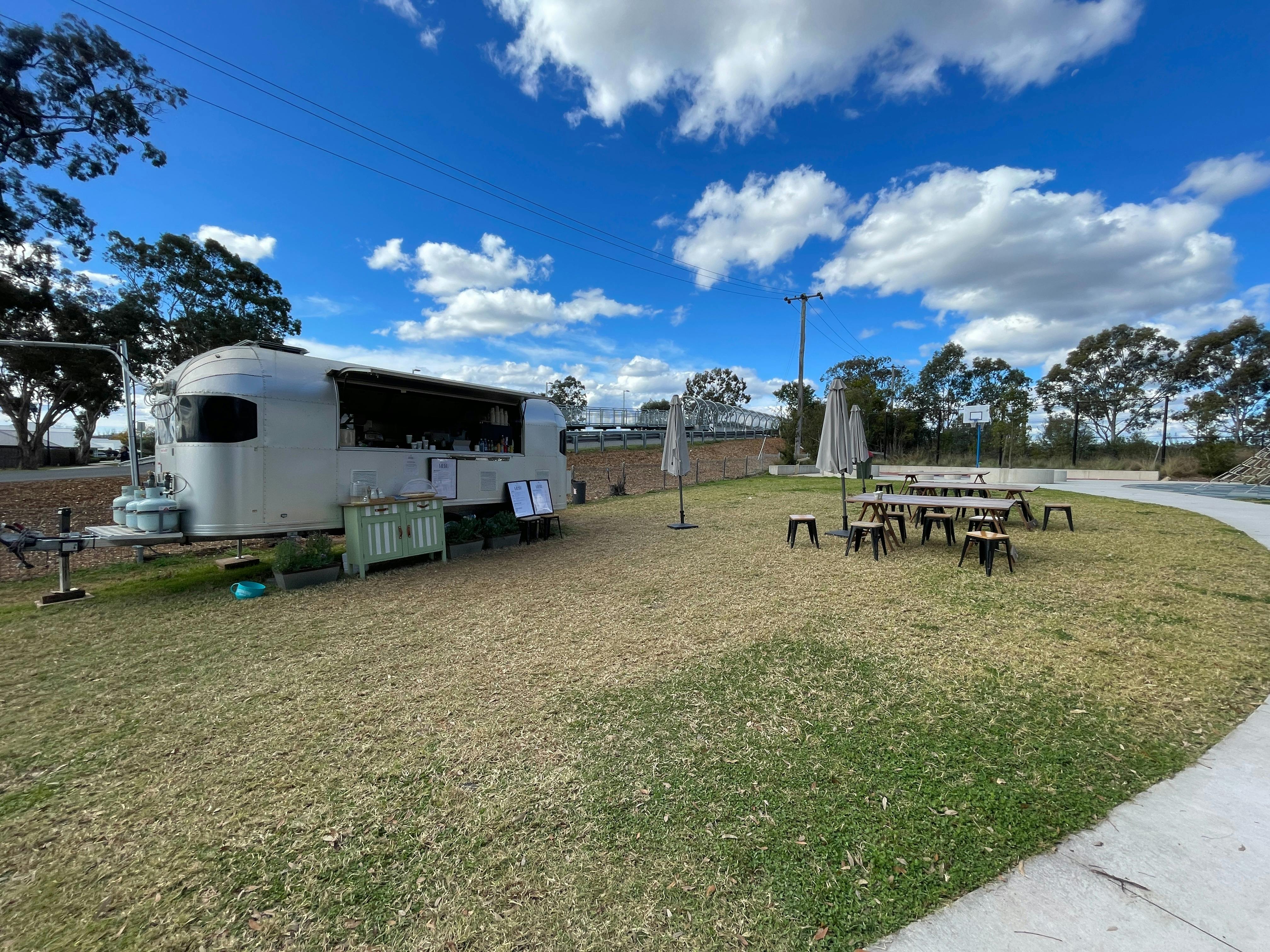 A silver caravan and seating
