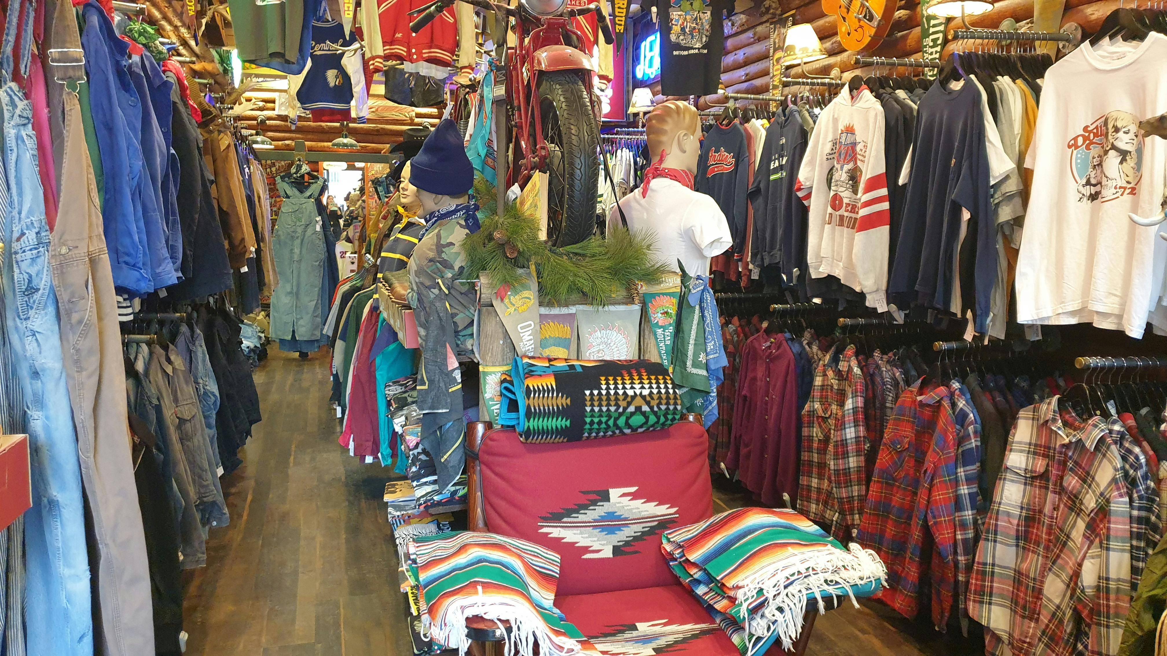 A clothing store is filled with garments ranging from workwear to checkered flannelette shirts.
