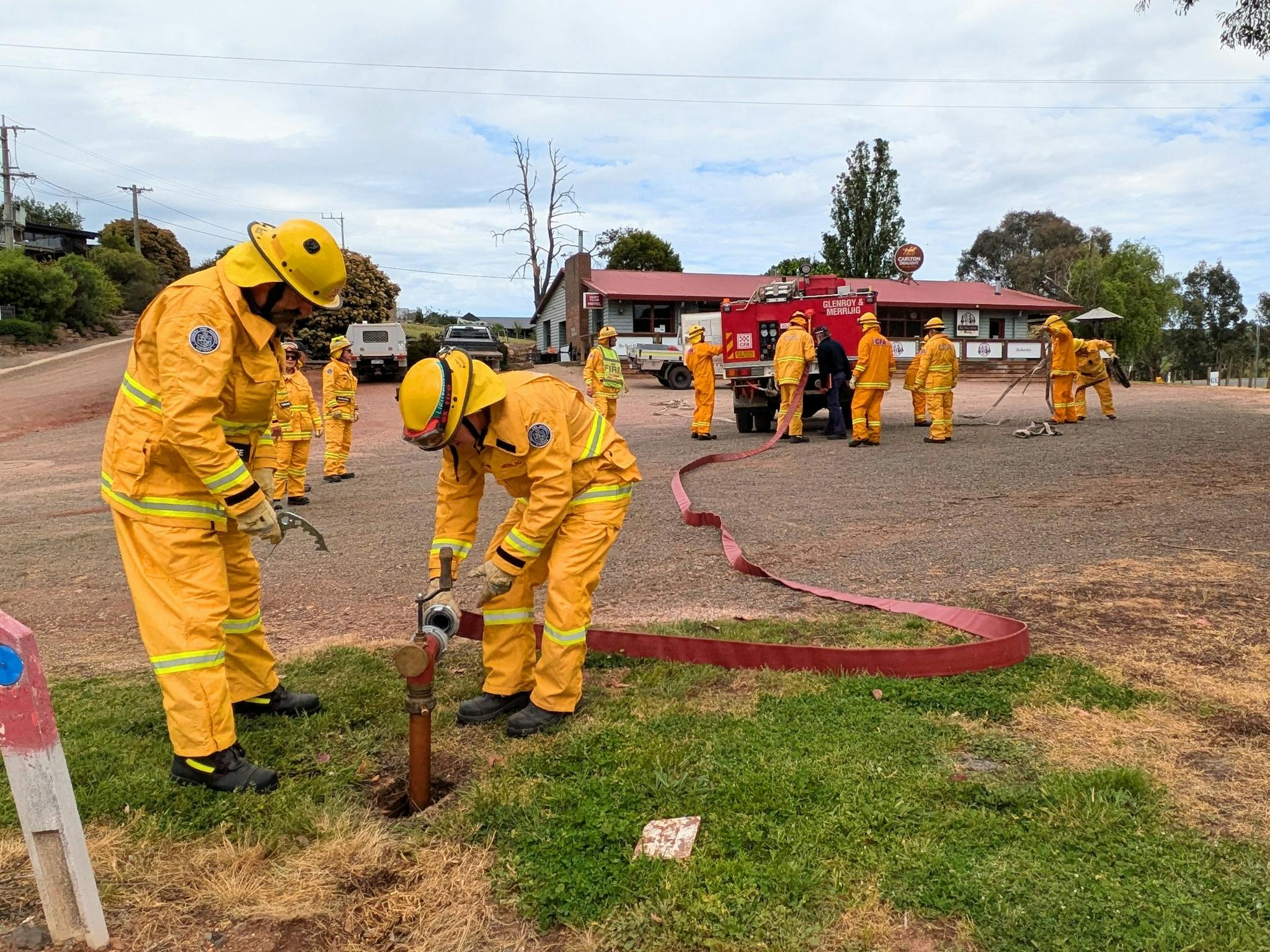 Firefighters attaching to in ground water supply
