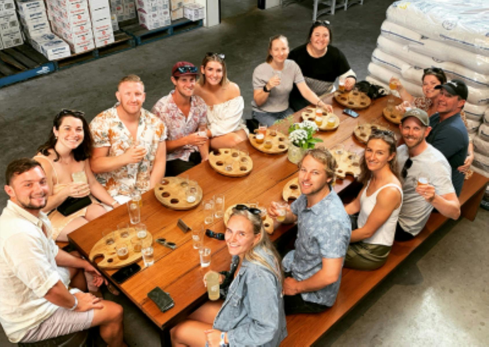 People enjoying a drink around the table at a brewery