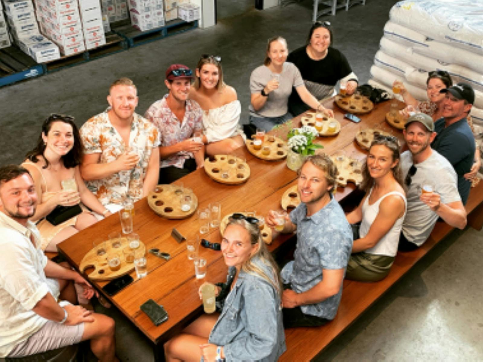 People enjoying a drink around the table at a brewery