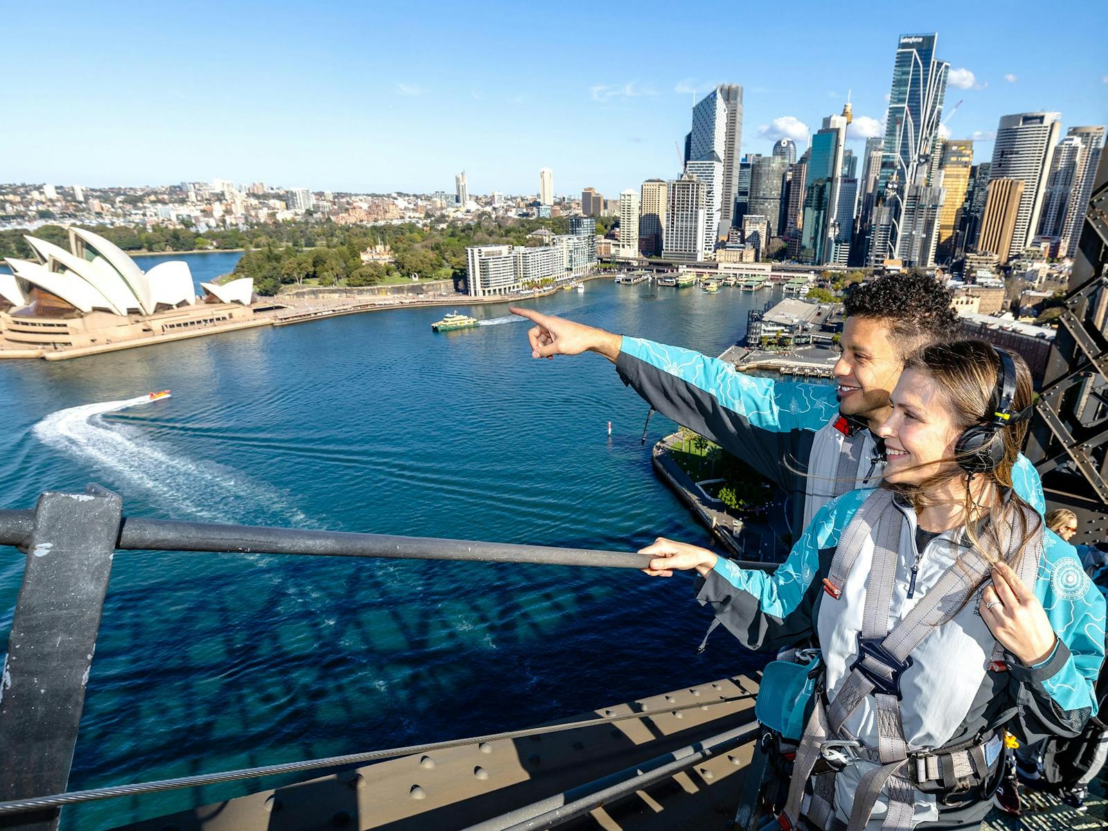 A couple on the Sydney Harbour Bridge looking out to the view of the Harbour