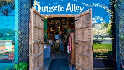Quizzic Alley's entrance, flanked by impressive timber castle doors.