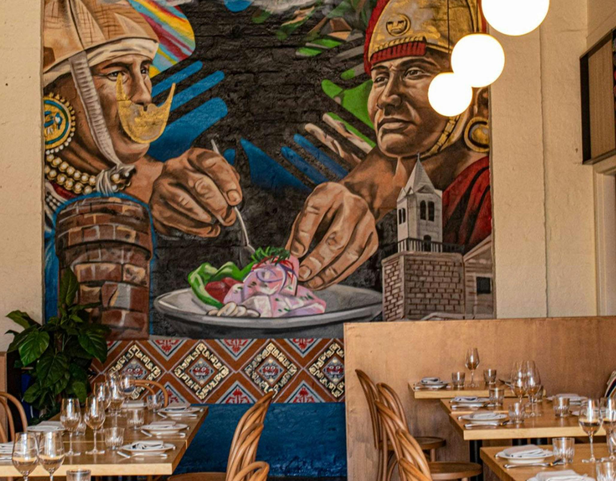 The image displays a vibrant and artistic dining area in the Warike restaurant, featuring a mural of