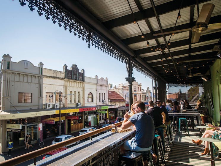 Patrons enjoying a drink on the sun-filled verandah at Newtown Hotel, Newtown