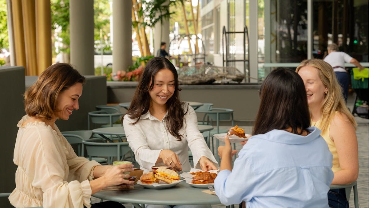 Four woman sitting and eating outdoor café
