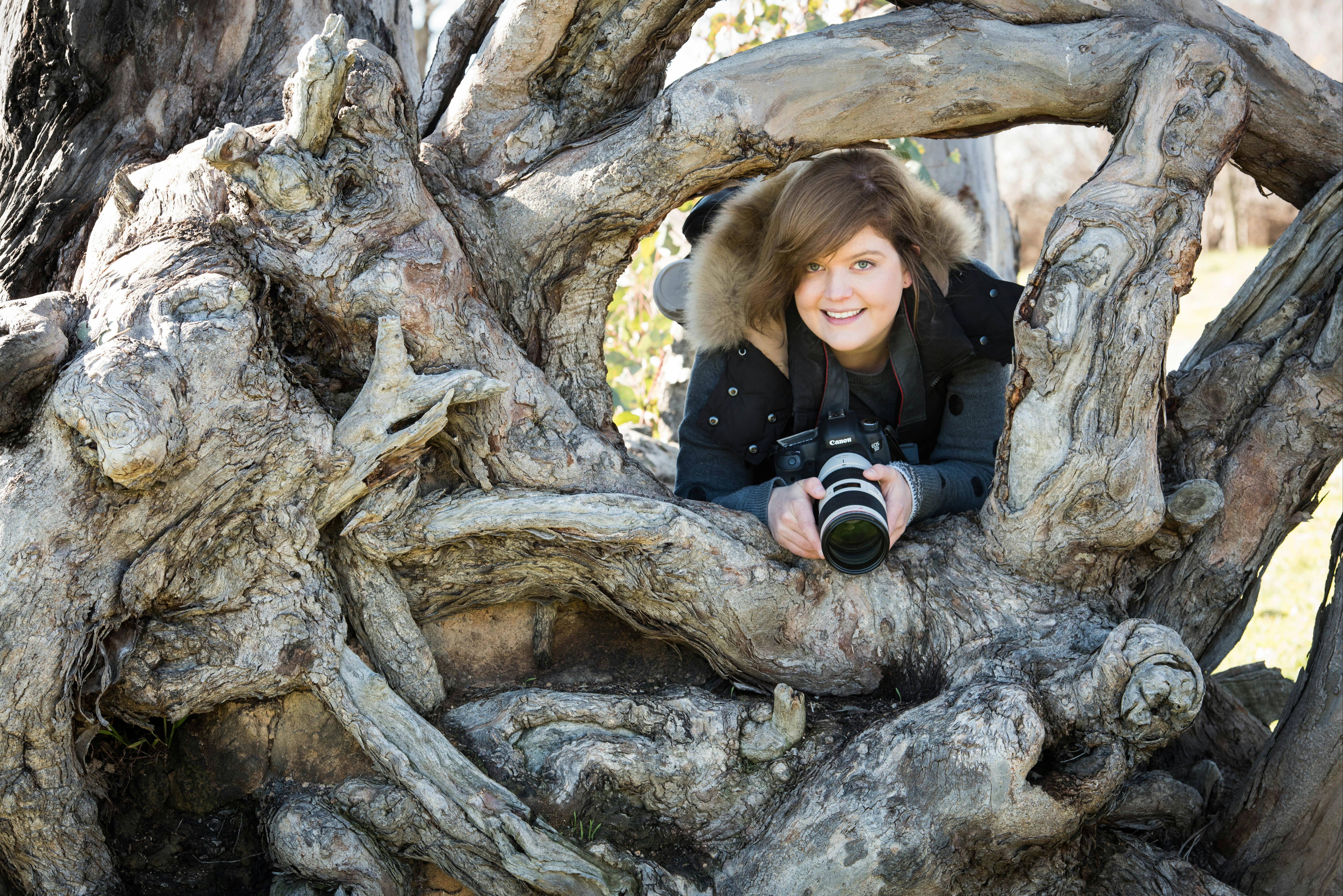Photographer in an interesting tree trunk