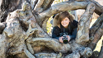 Photographer in an interesting tree trunk
