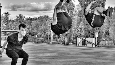 3 young men perform a backsault.
