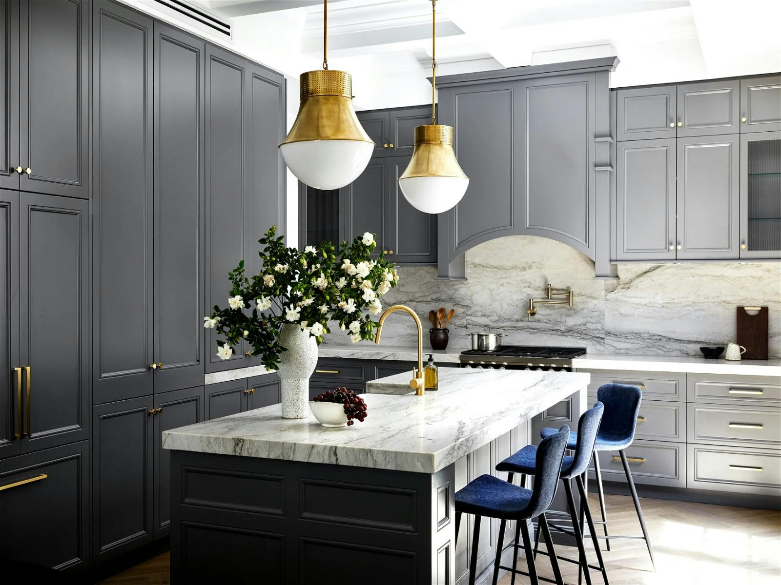a large kitchen that extends into the dining space and out to the beautiful garden and living room