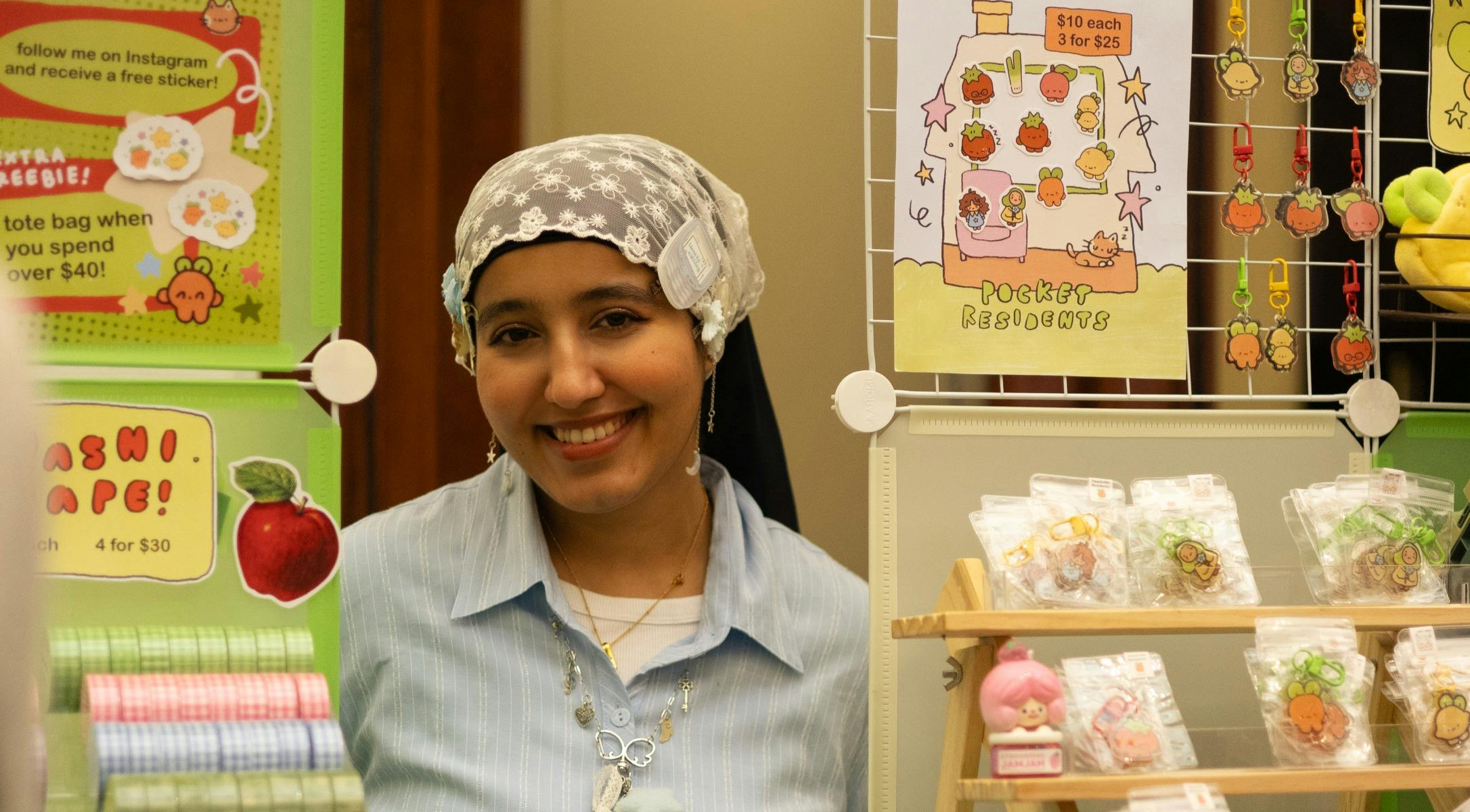 A photograph of a woman smiling at a market stall.