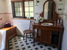 Victorian style timber vanity, shower over spa, Sukin toiletries