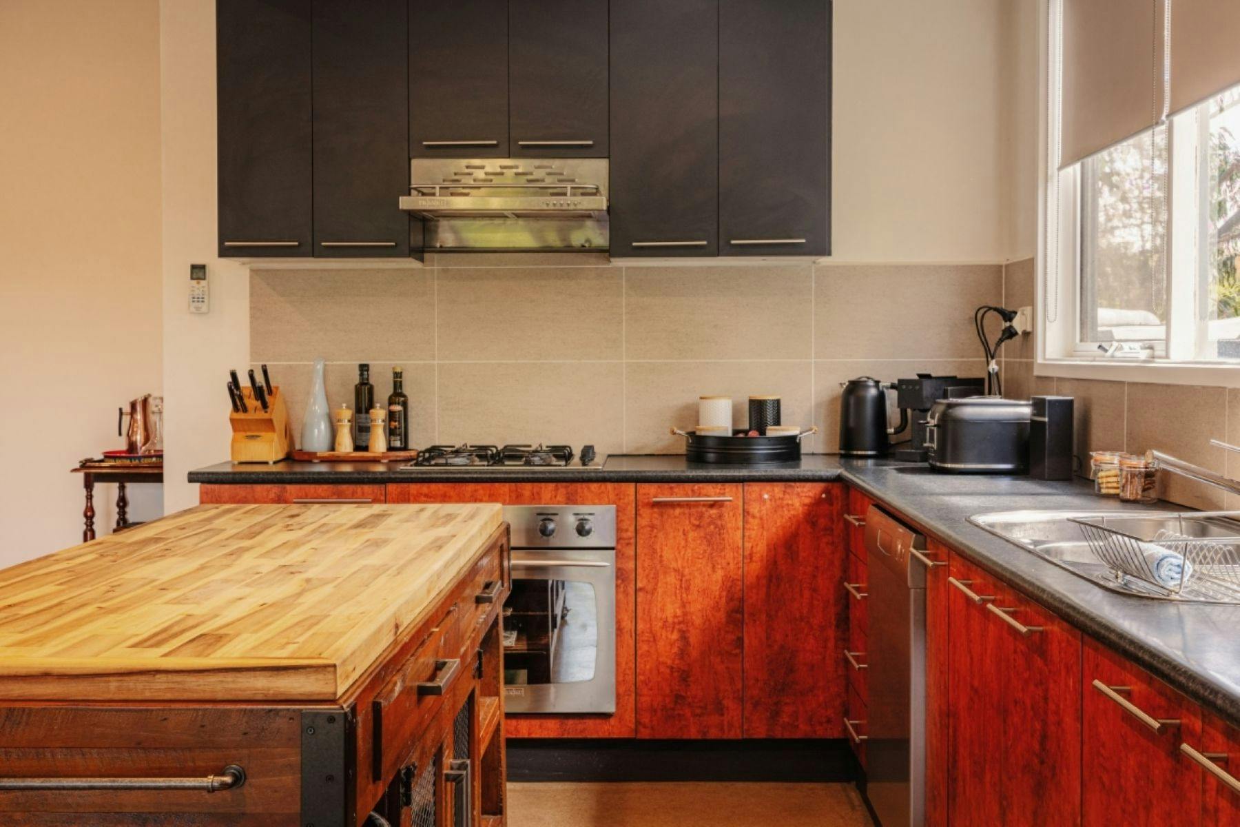 A kitchen with appliances on the counter top