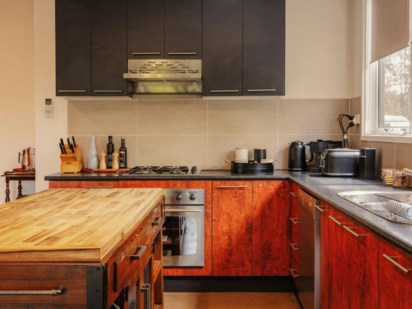 A kitchen with appliances on the counter top