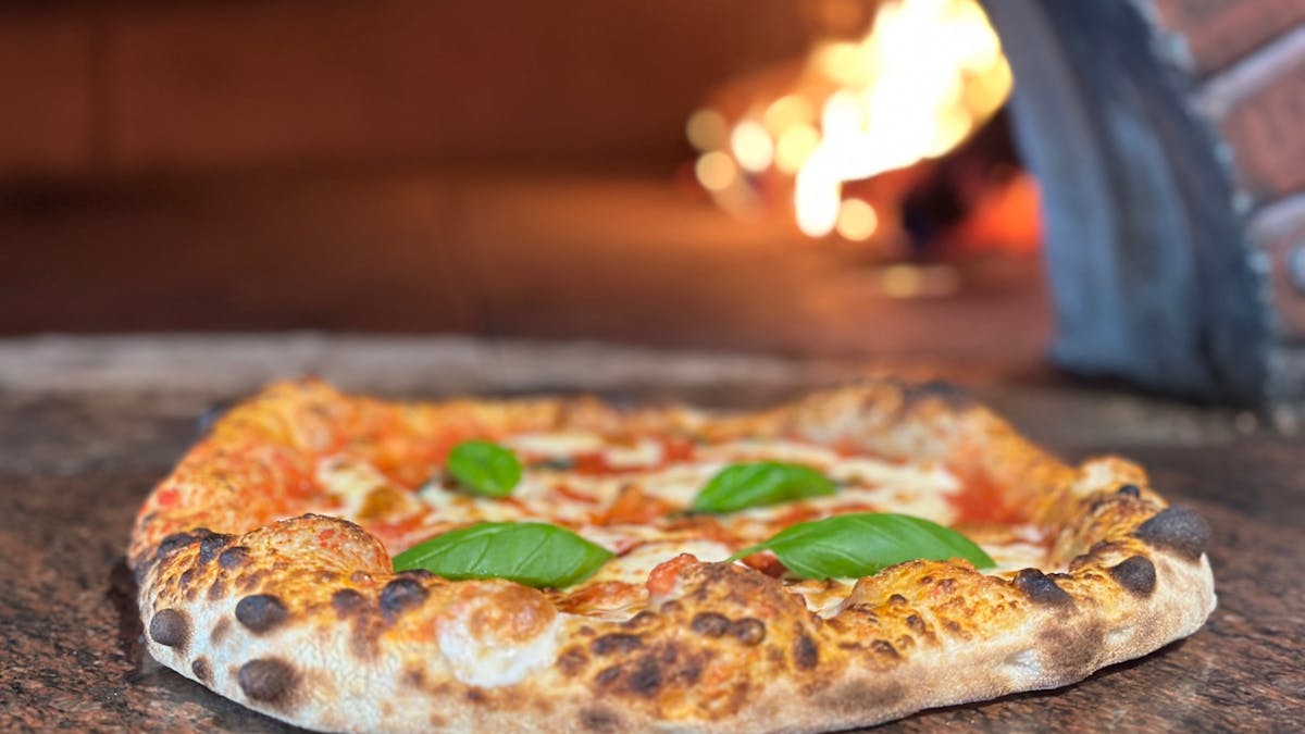 Cozy Italian restaurant with wood-fired pizzas and warm, inviting atmosphere.