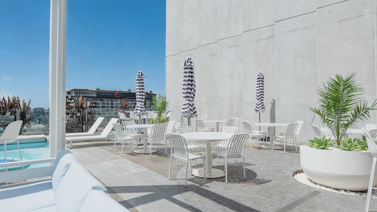 outside tables for outside pool deck dining with views of Southbank