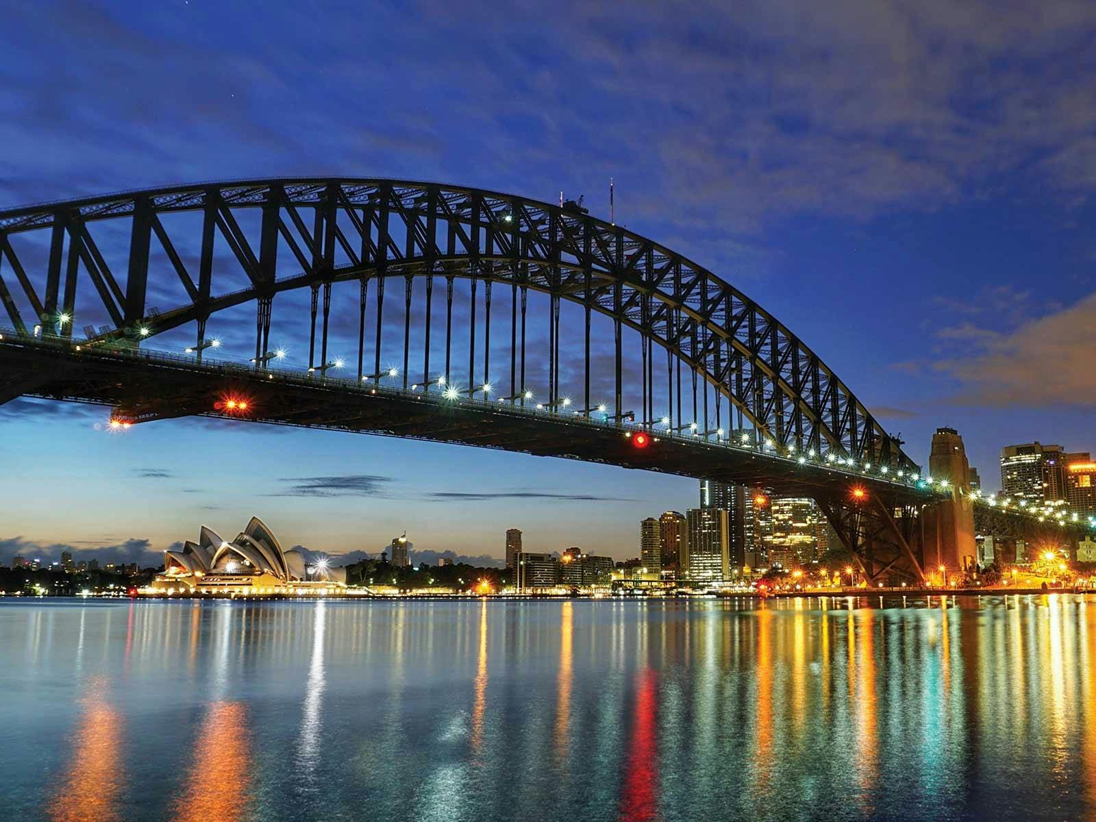 The Harbour Bridge and Opera House seen from the Showboat dinner cruise at night