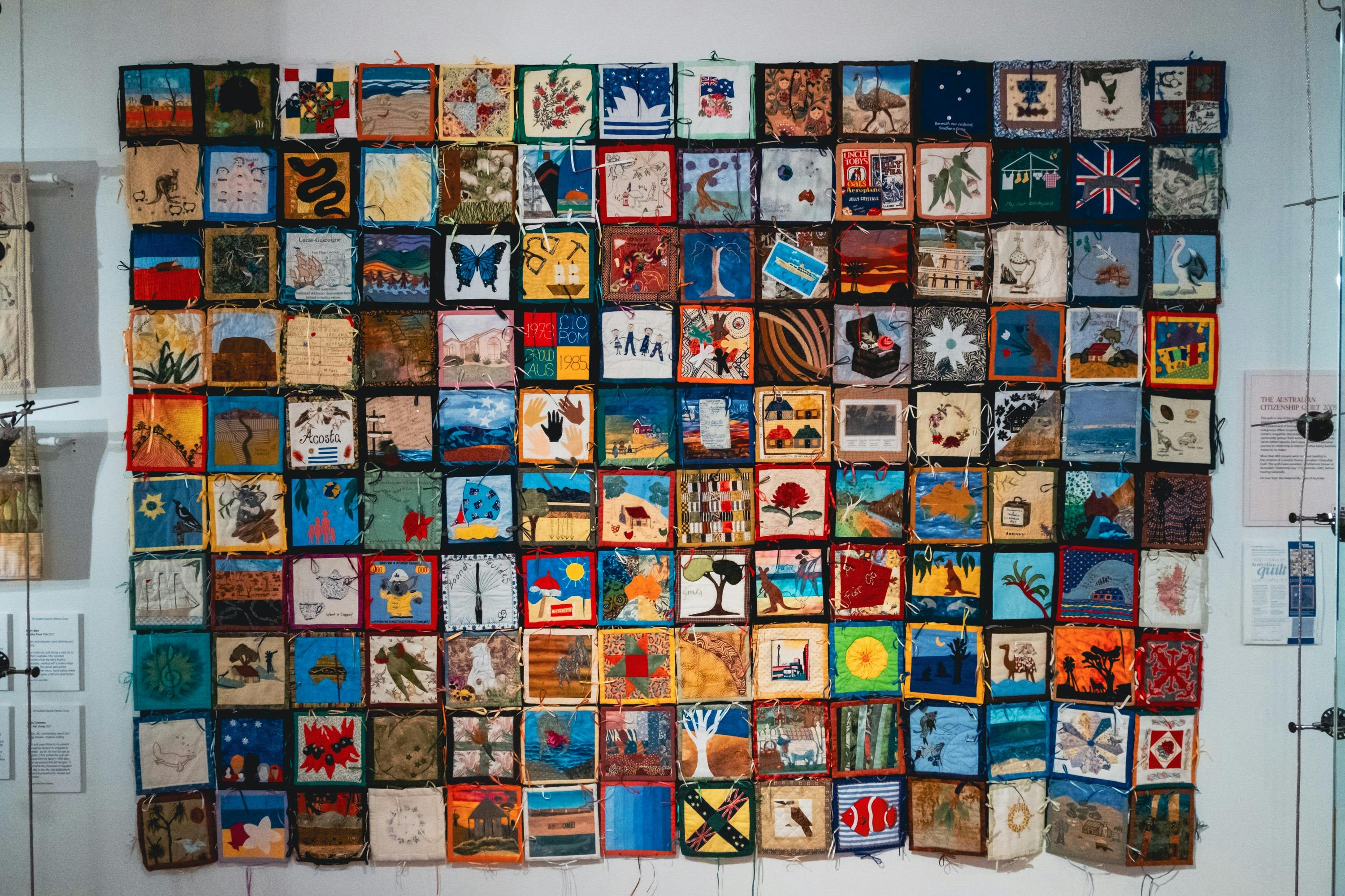 The Immigration Quilt with patches created by different makers to signify connection to country