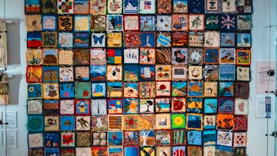 The Immigration Quilt with patches created by different makers to signify connection to country