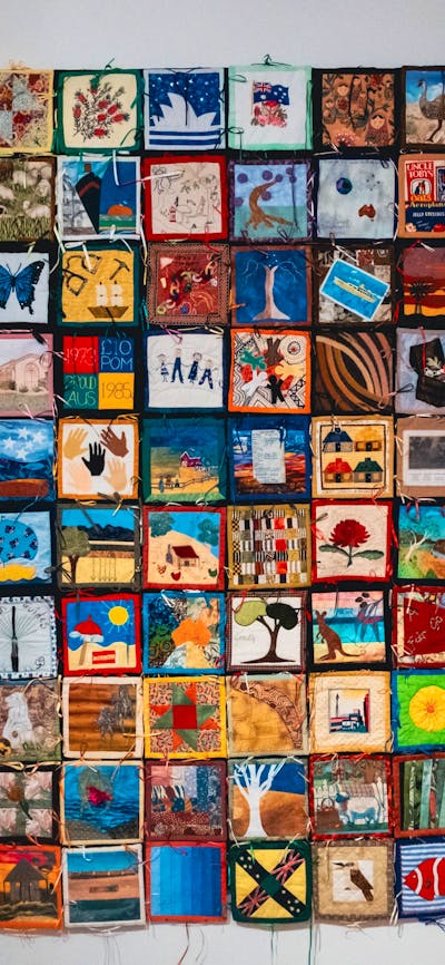 The Immigration Quilt with patches created by different makers to signify connection to country
