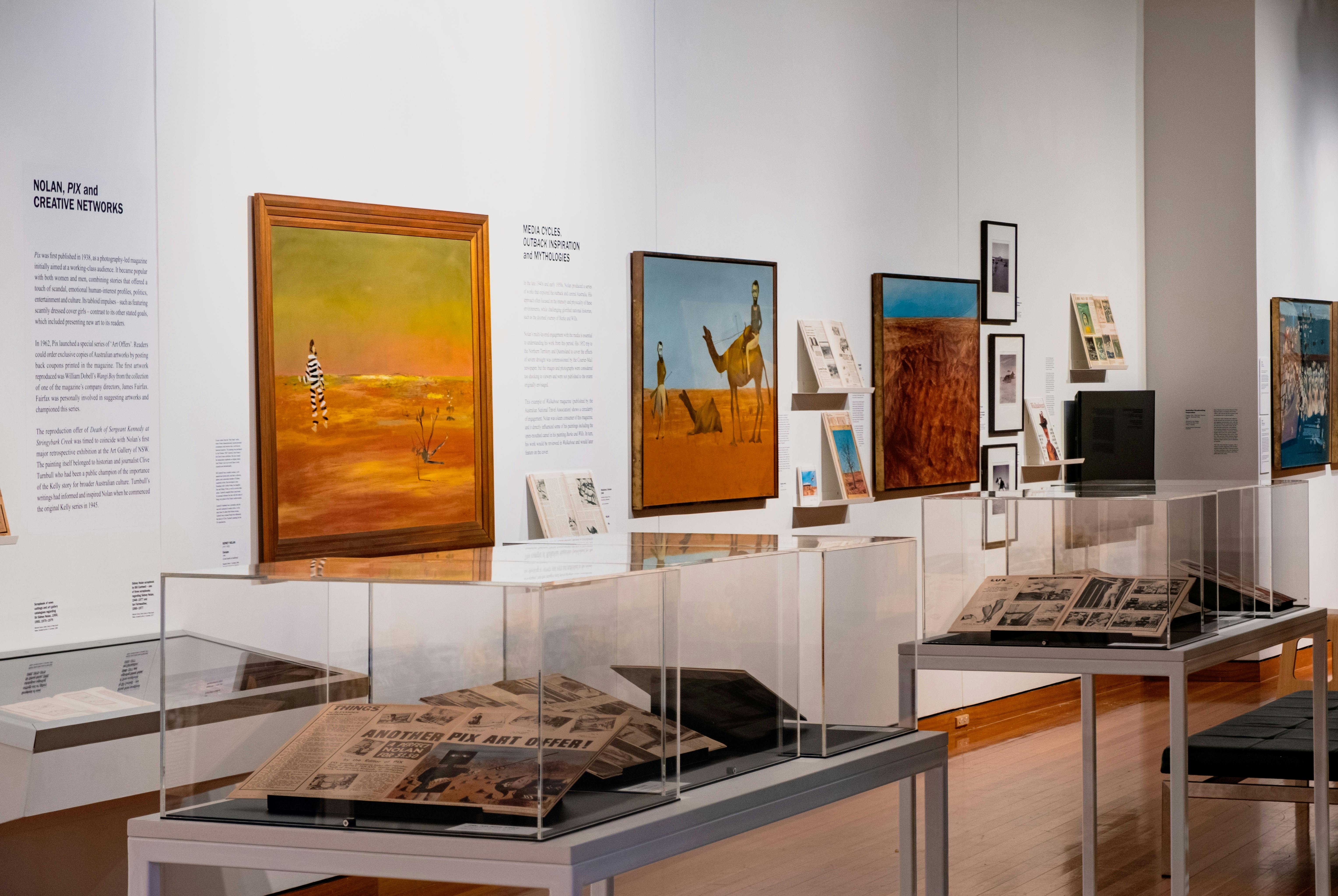 View of multiple Sidney Nolan paintings and vitrines with articles on Nolan