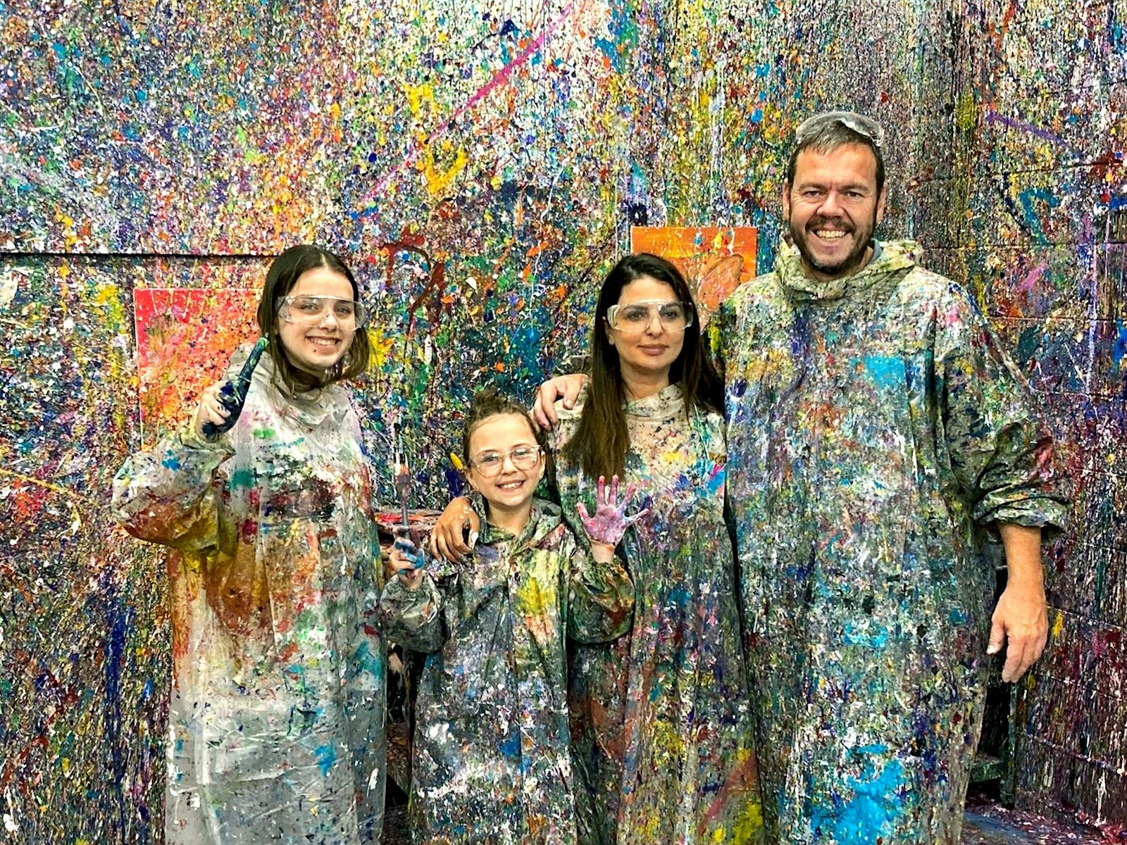 Family in front of colourful splatter paint wall, Kaboo Studio