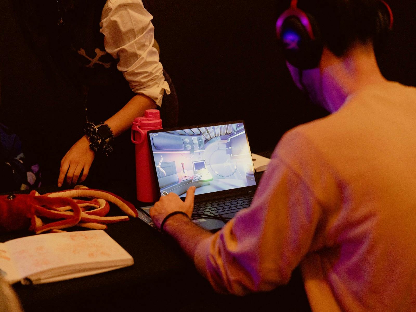 Man in front of a screen wearing headphones