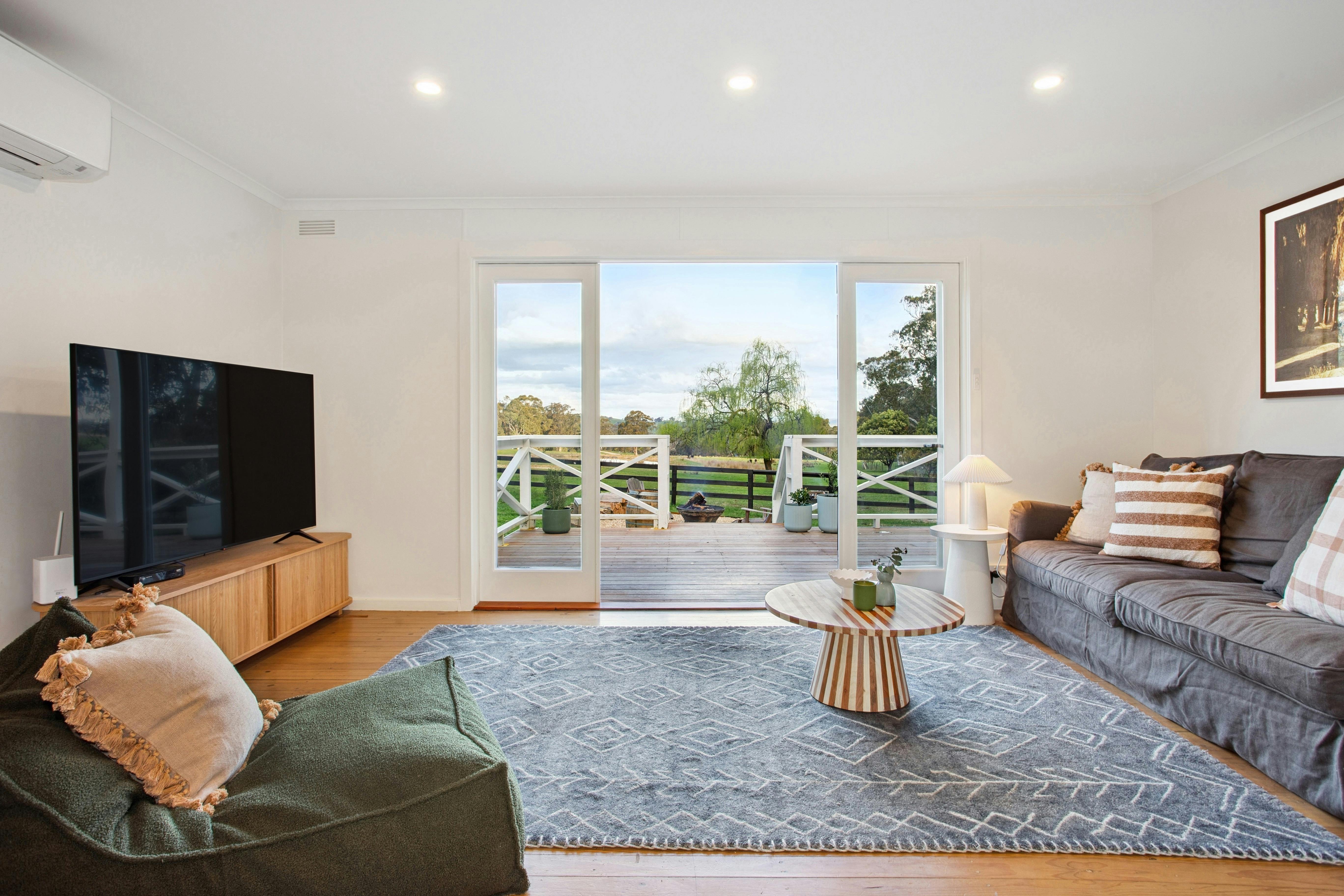 iving room at Valley Park High Country Retreat with plush sofa, beanbag, smart TV