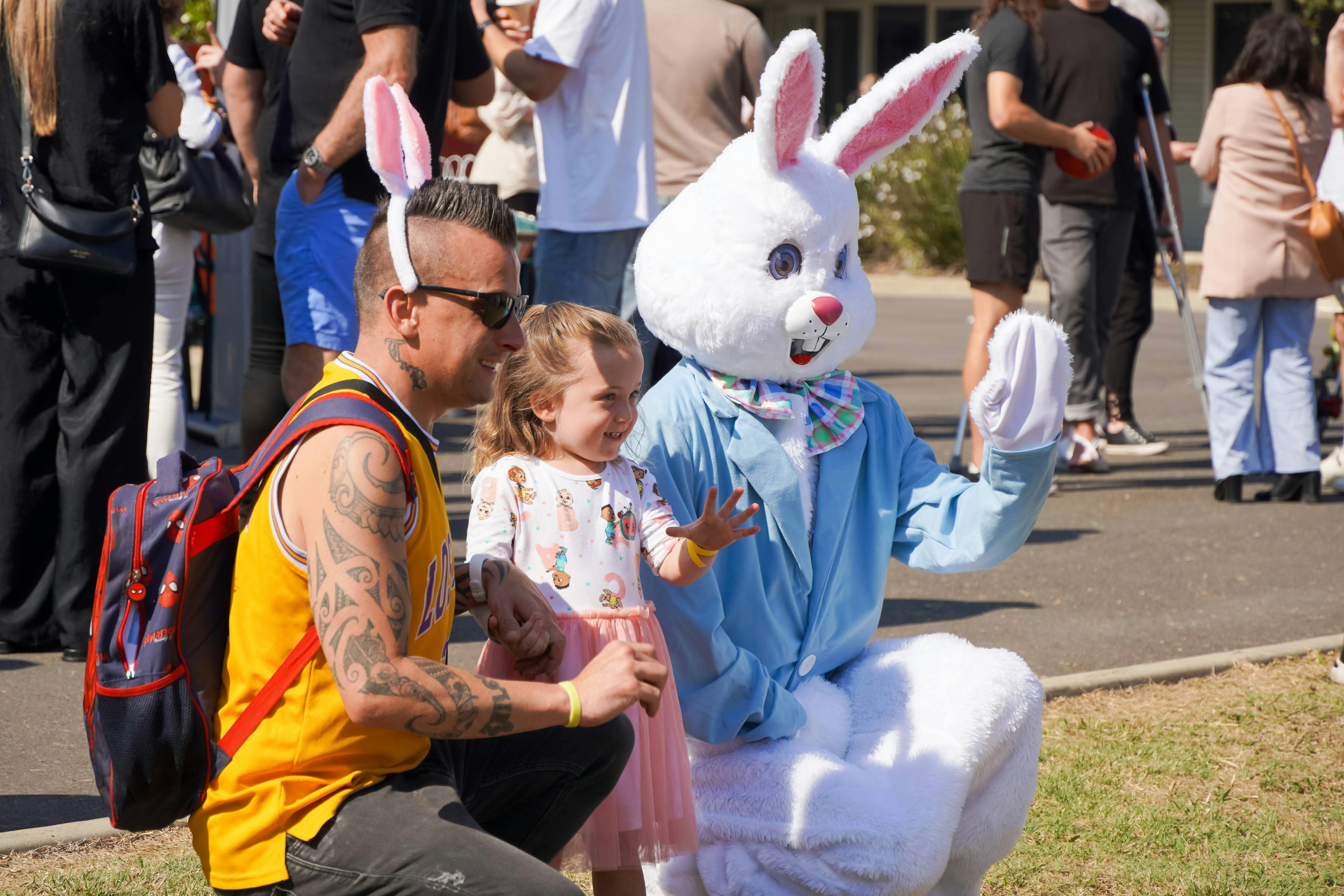 A family pose for a photo with the Easter Bunny