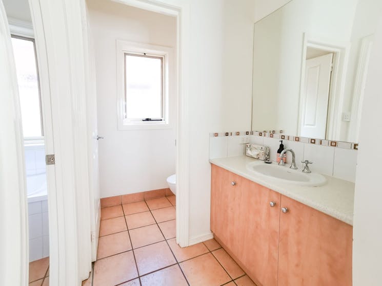 Access to main bathroom with shower, make up area and toilet