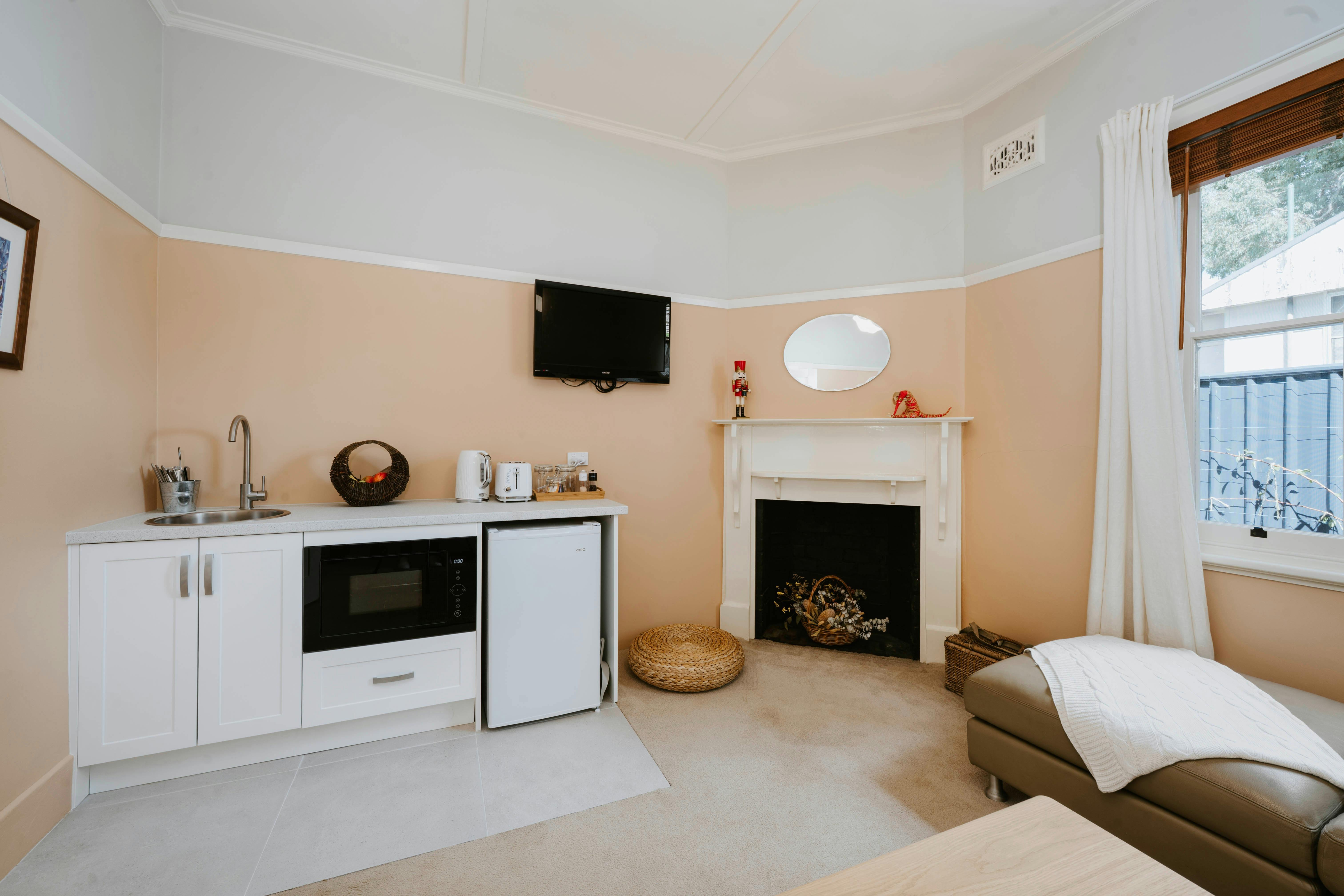 Kitchenette - well appointed, m/w, big bar fridge, coffee pod, sink, toaster etc. within Lounge Rm