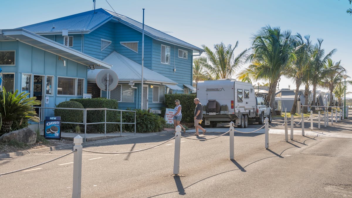 Image of Cotton Tree Holiday Park Office. Wide shot with caravan and couple walking in to office. Image of Cotton Tree Holiday Park Office. Wide shot with caravan and couple walking in to office.