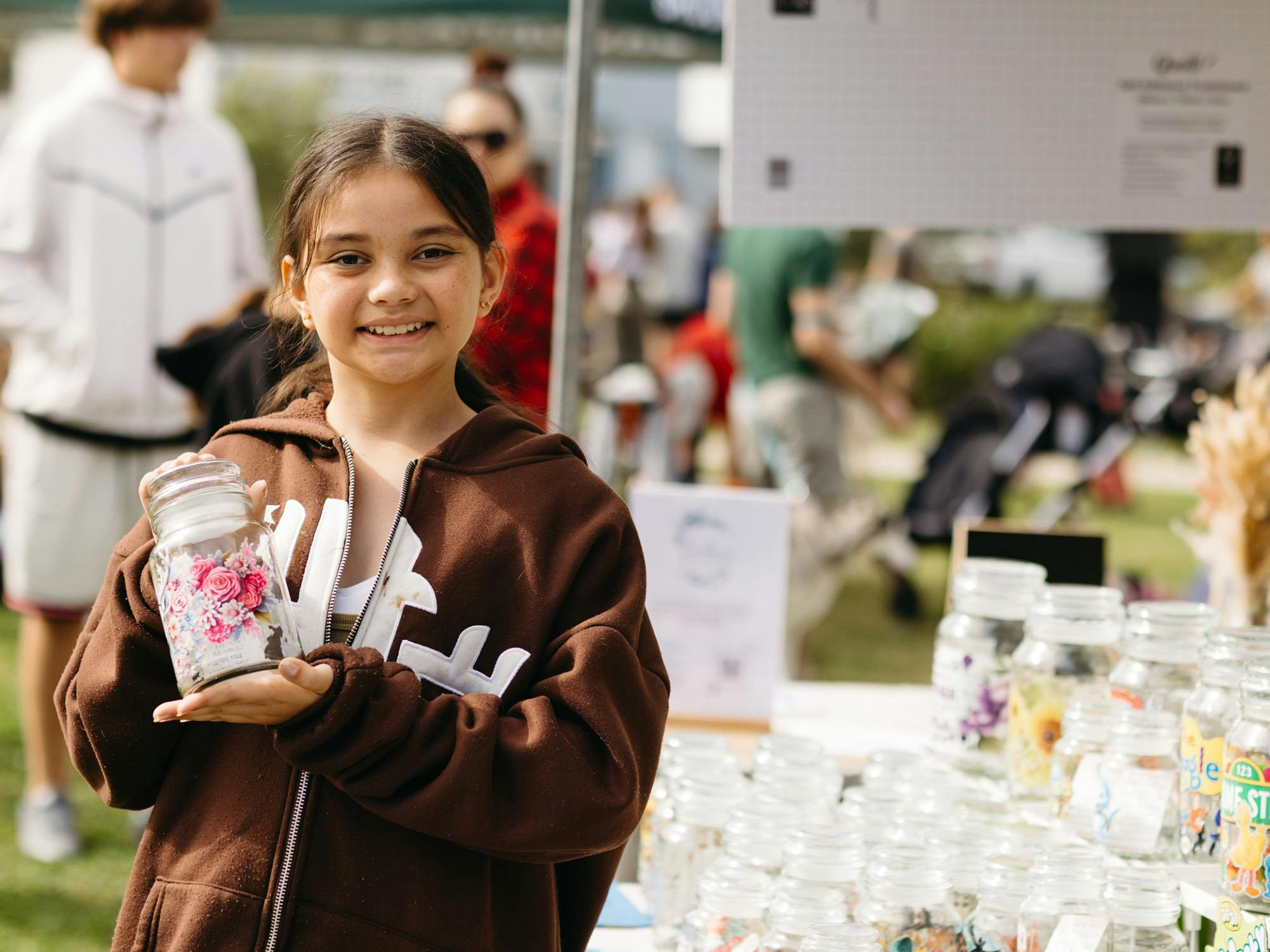 Girl holding jar of stickers