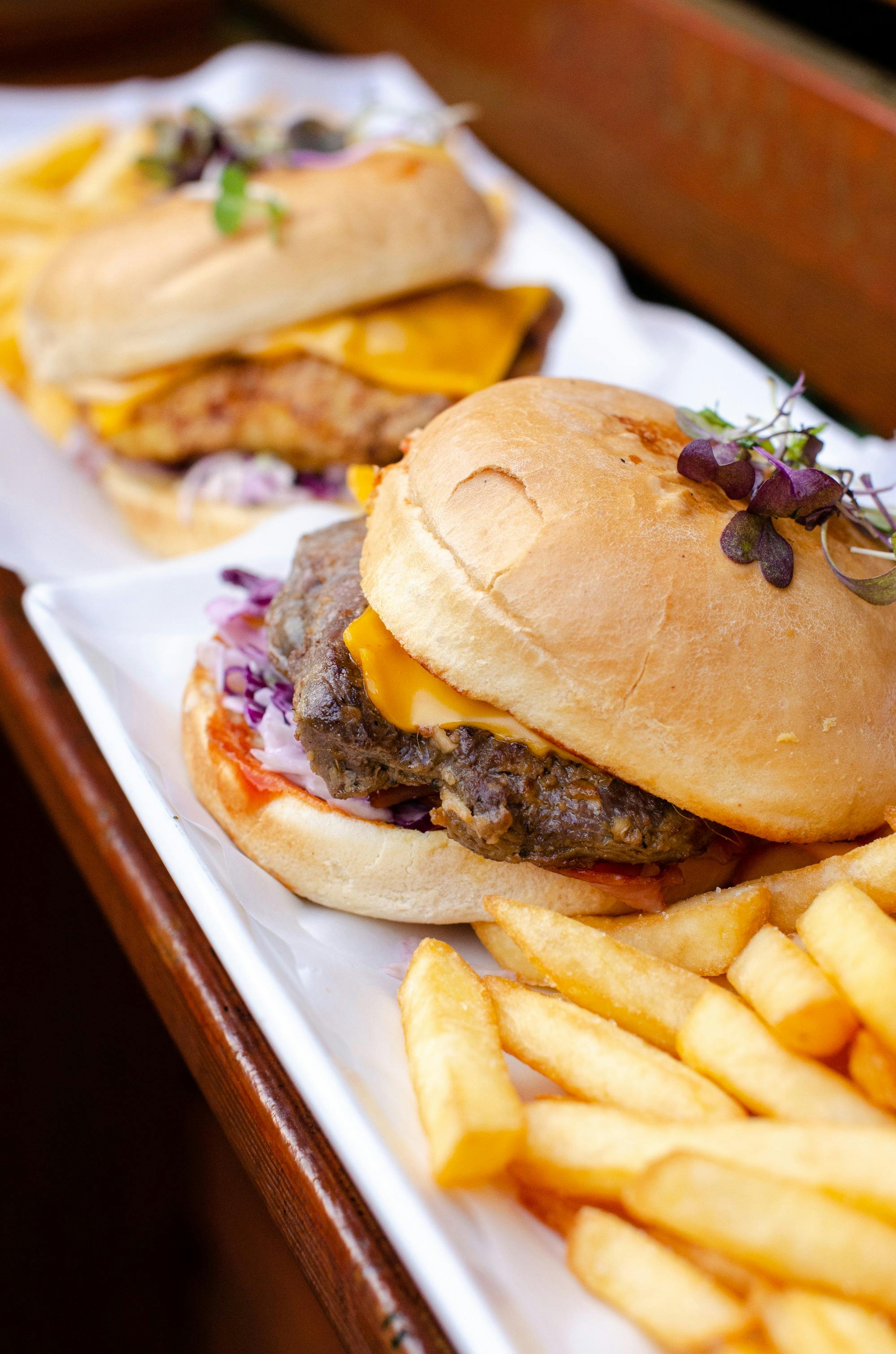Wallaby Burger with chips in foreground and Southern Fried Chicken Burger with chips in background