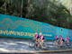 Group of cyclists riding past the Mt Buller welcome sign