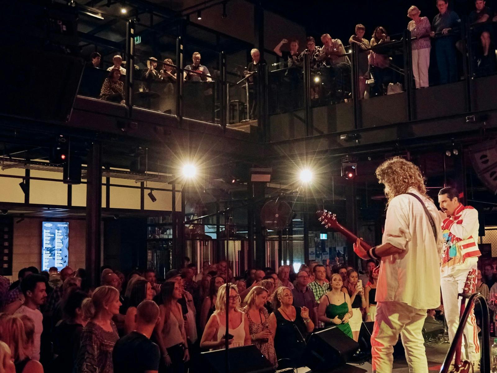 Crowd enjoying a live performance by Killer Queen Experience at The District.