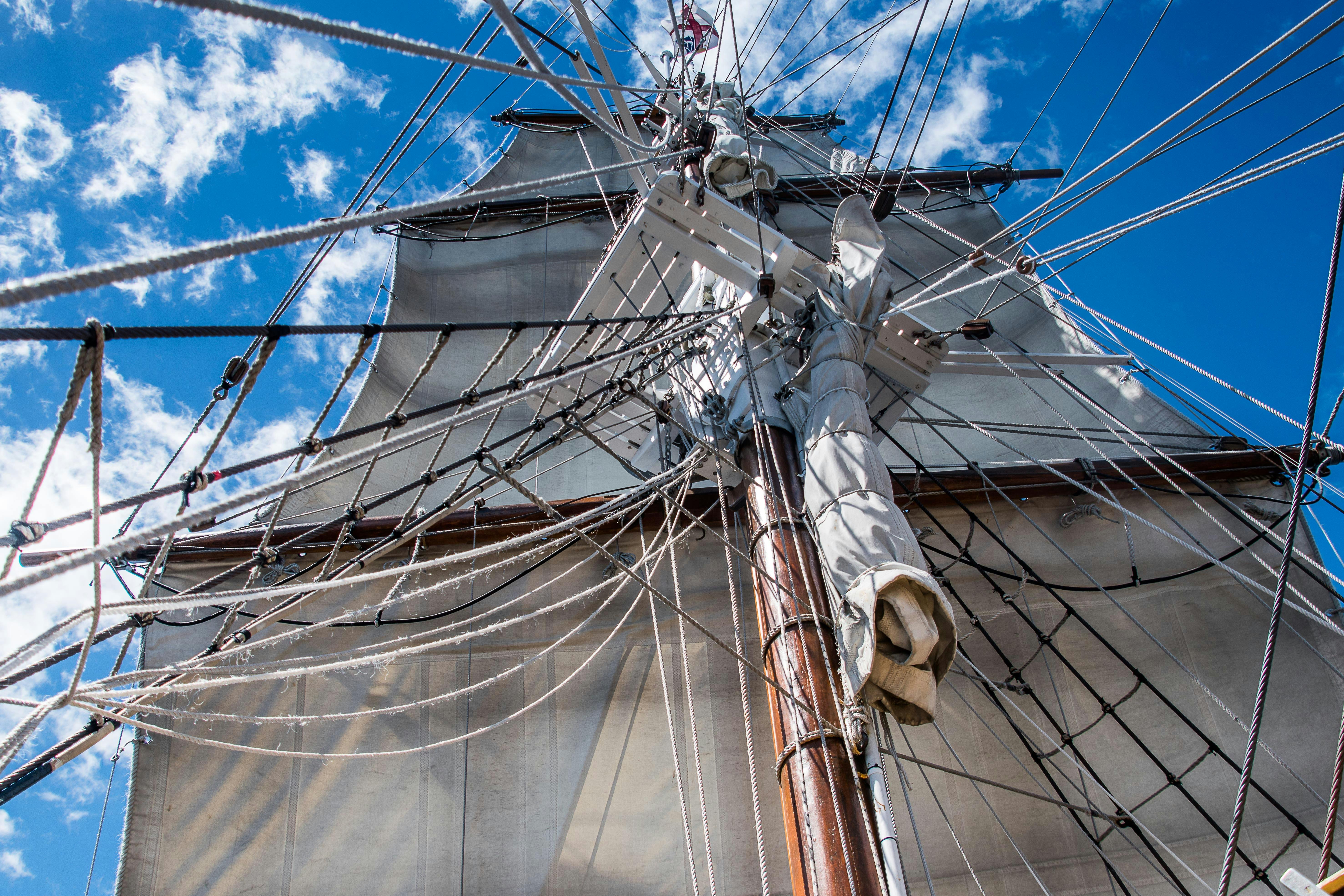 looking up the mast at full sails set on a sunny day